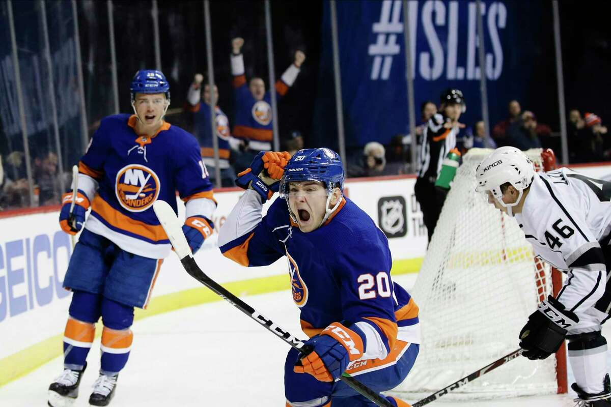 The Islanders’ Kieffer Bellows (20) celebrates after scoring his first NHL goal, as teammate Anthony Beauvillier, left, and the Kings’ Blake Lizotte, right, reacton Feb. 6 in New York.