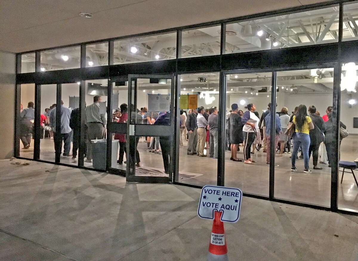 Missouri City officials filed suit on Dec. 2, 2020 against Fort Bend County for restricting early voting to just one polling location for city residents who reside in Harris County. In this file image, voters wait in line to cast ballots at the Missouri City City Hall polling location on Nov. 5, 2019.