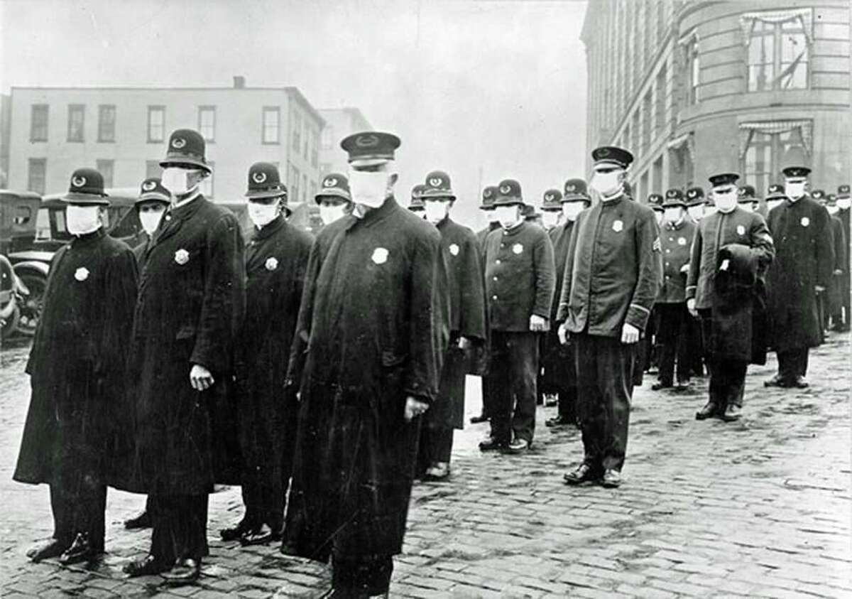 Police in Seattle wearing masks provided by the Red Cross during the influenza epidemic in 1918.