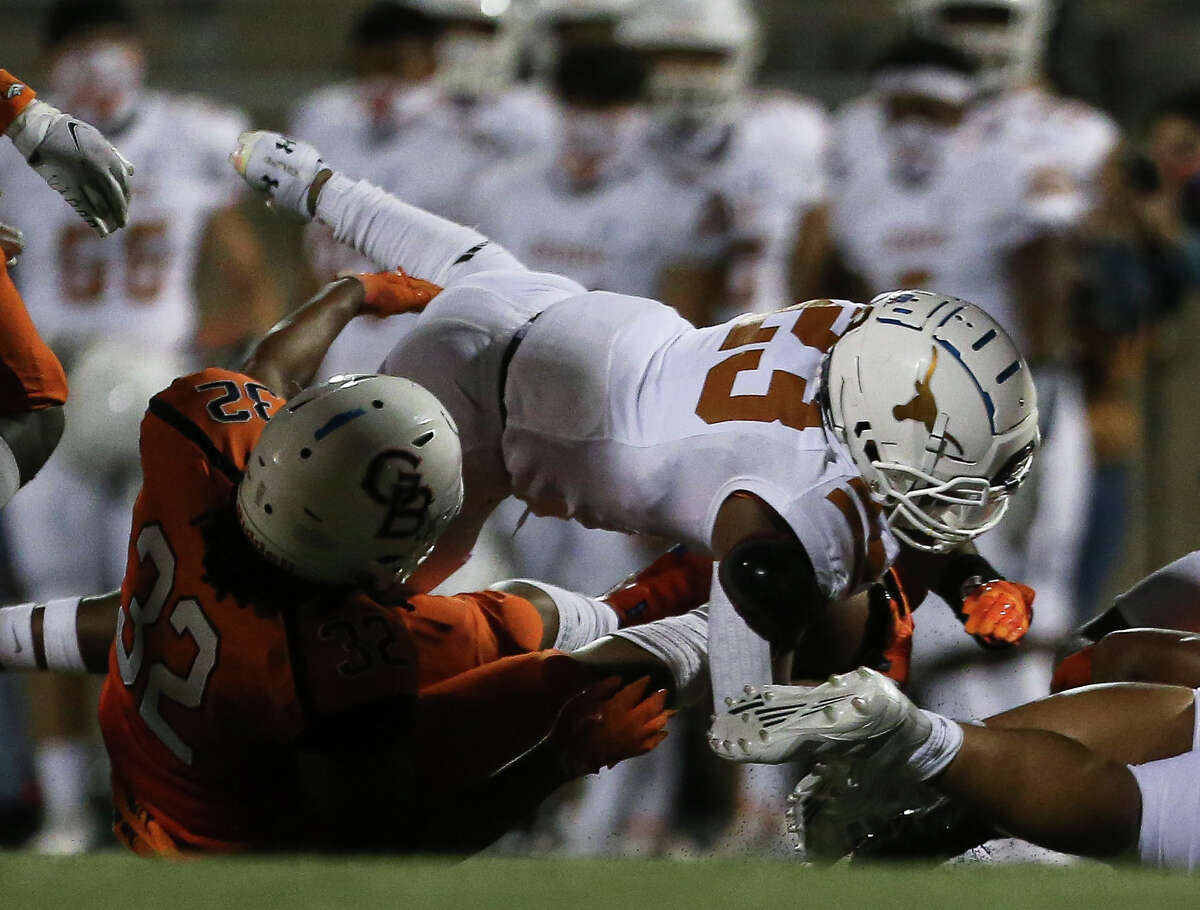 Dobie Longhorns running back Trevion Williams makes a down over Bush Broncos linebacker Charlton Bibb during the second quarter of the game Friday, Oct. 9, 2020, at Hall Stadium in Missouri City.