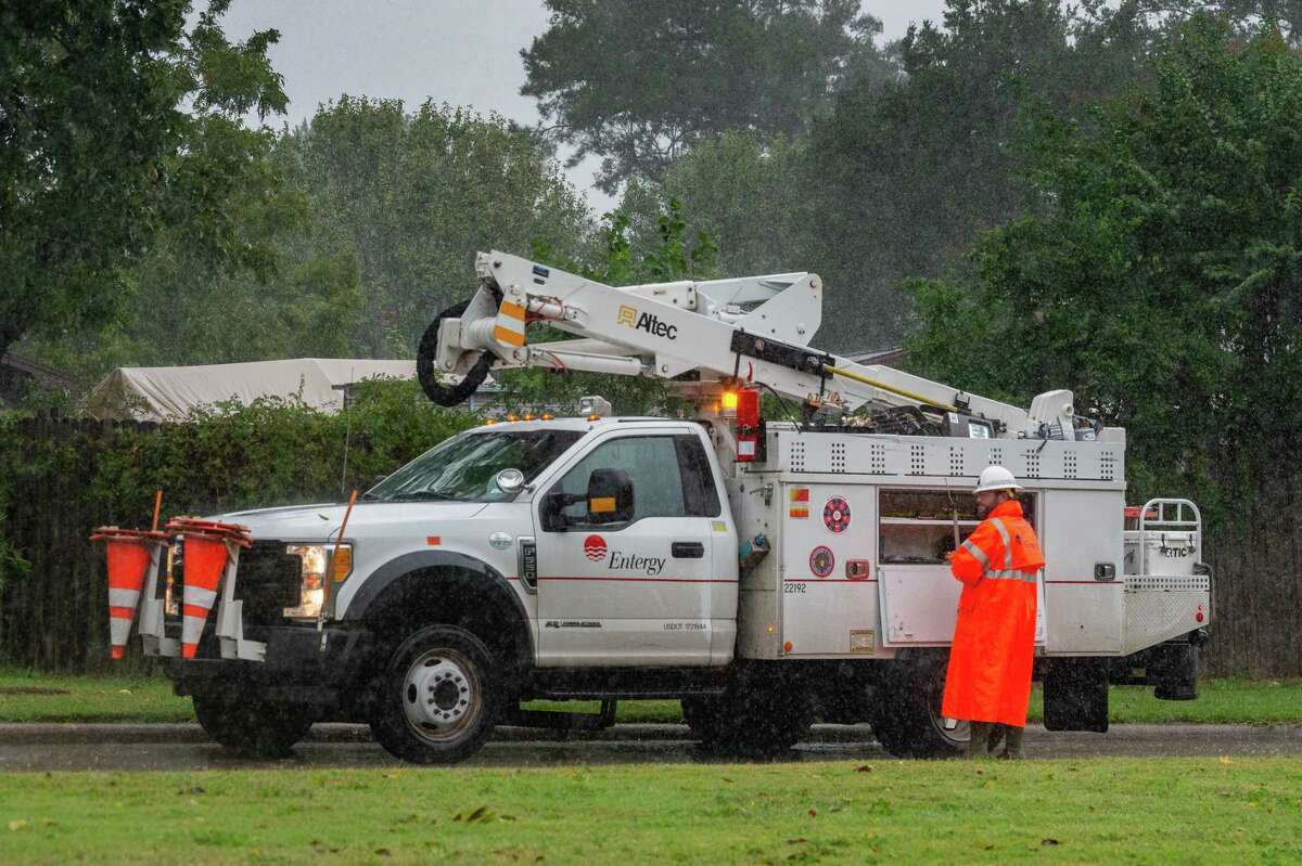 An Entergy employee works in the pouring rain on Phelan Boulevard on Friday afternoon. With Hurricane Delta churning out in the Gulf, Southeast Texans prepare for another possible storm situation. Photo made on October 09, 2020. Fran Ruchalski/The Enterprise