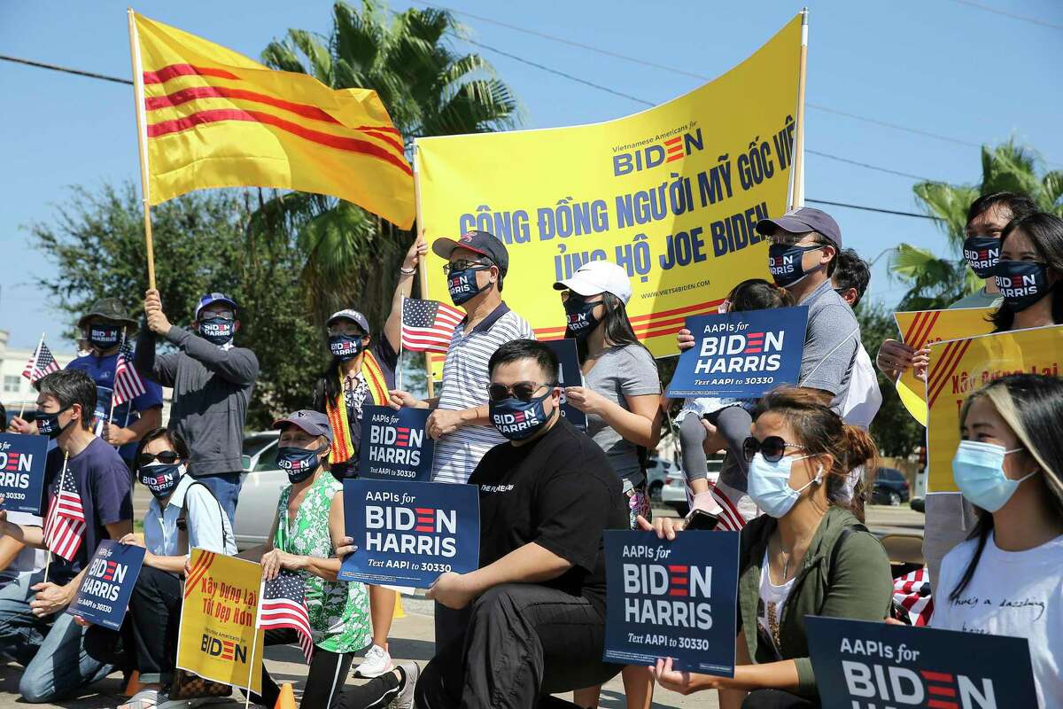 Vietnamese Americans take a photograph during a rally for Joe Biden and Kamala Harris at the corner of Bellaire Boulevard and Boone Road Saturday, Oct. 10, 2020, in Houston. This rally is coordinated alongside other cities across the country for a national Vietnamese American for Biden day of action.