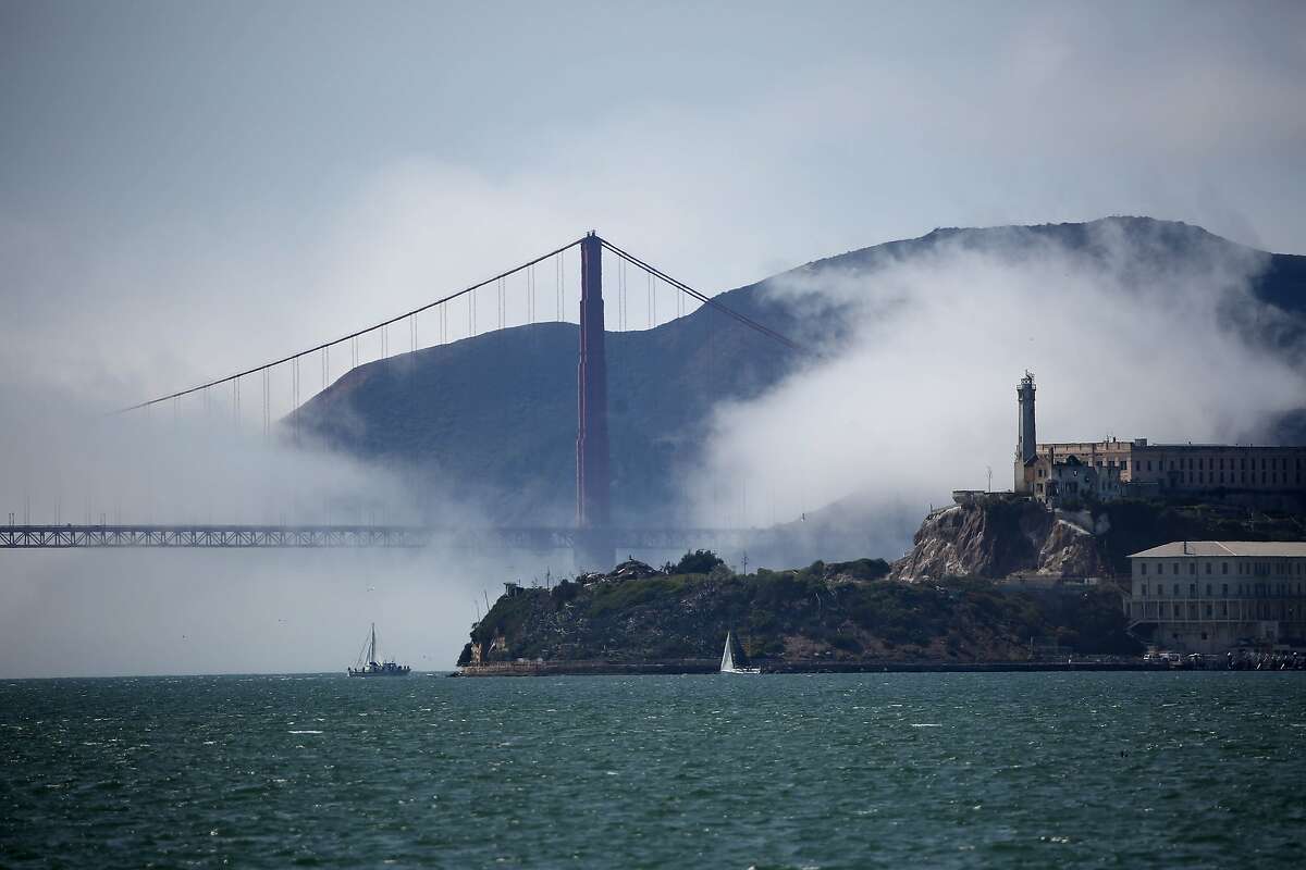 Low fog swirls around Alcatraz and the Golden Gate Bridge under clear skies as boats sail on the San Francisco Bay. A group of Bay Area lawmakers want more federal dollars invested into the bay’s restoration.