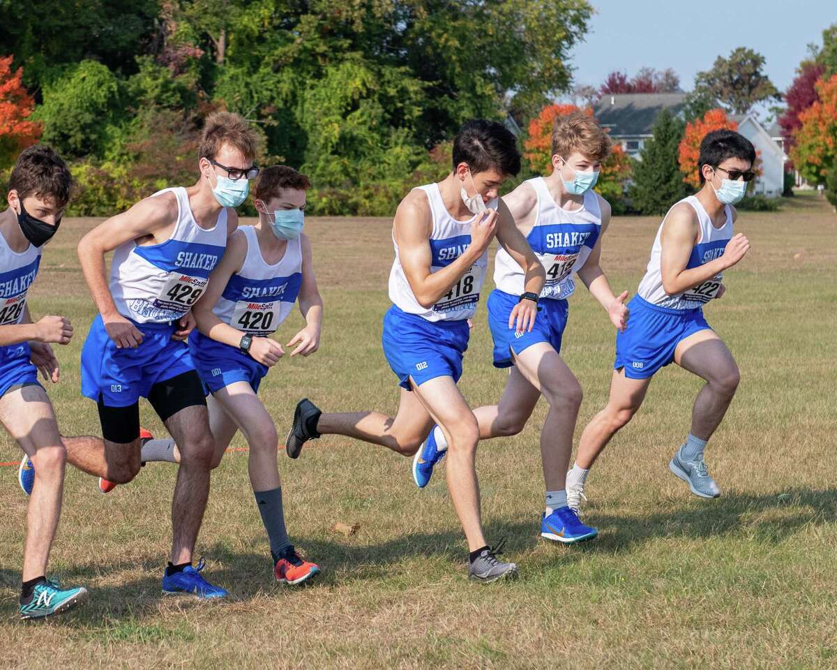 The Shaker boys varsity and junior varsity cross country teams against Burnt Hills Ballston Lake at the Crossings in Colonie, NY, on Saturday, Oct. 10, 2020 Zack Diehl, center, is adjusting his mask and checking his watch. (Jim Franco, special to the Times Union.)