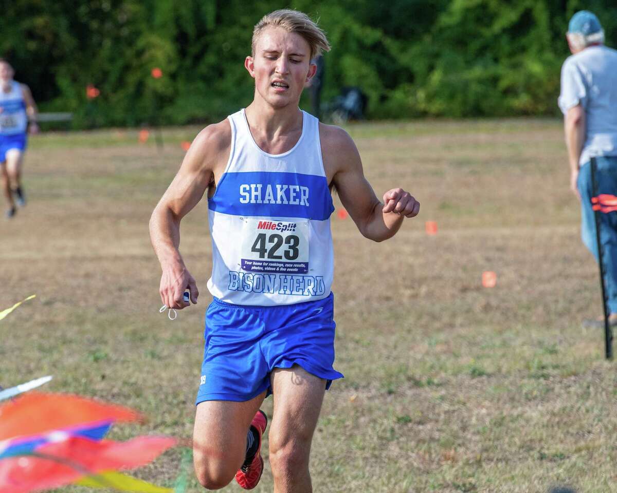 Shaker boys varsity cross country runner Vinny Levchenko carries his mask across the finish line during a race against Burnt Hills Ballston Lake at the Crossings in Colonie, NY, on Saturday, Oct. 10, 2020 (Jim Franco, special to the Times Union.)
