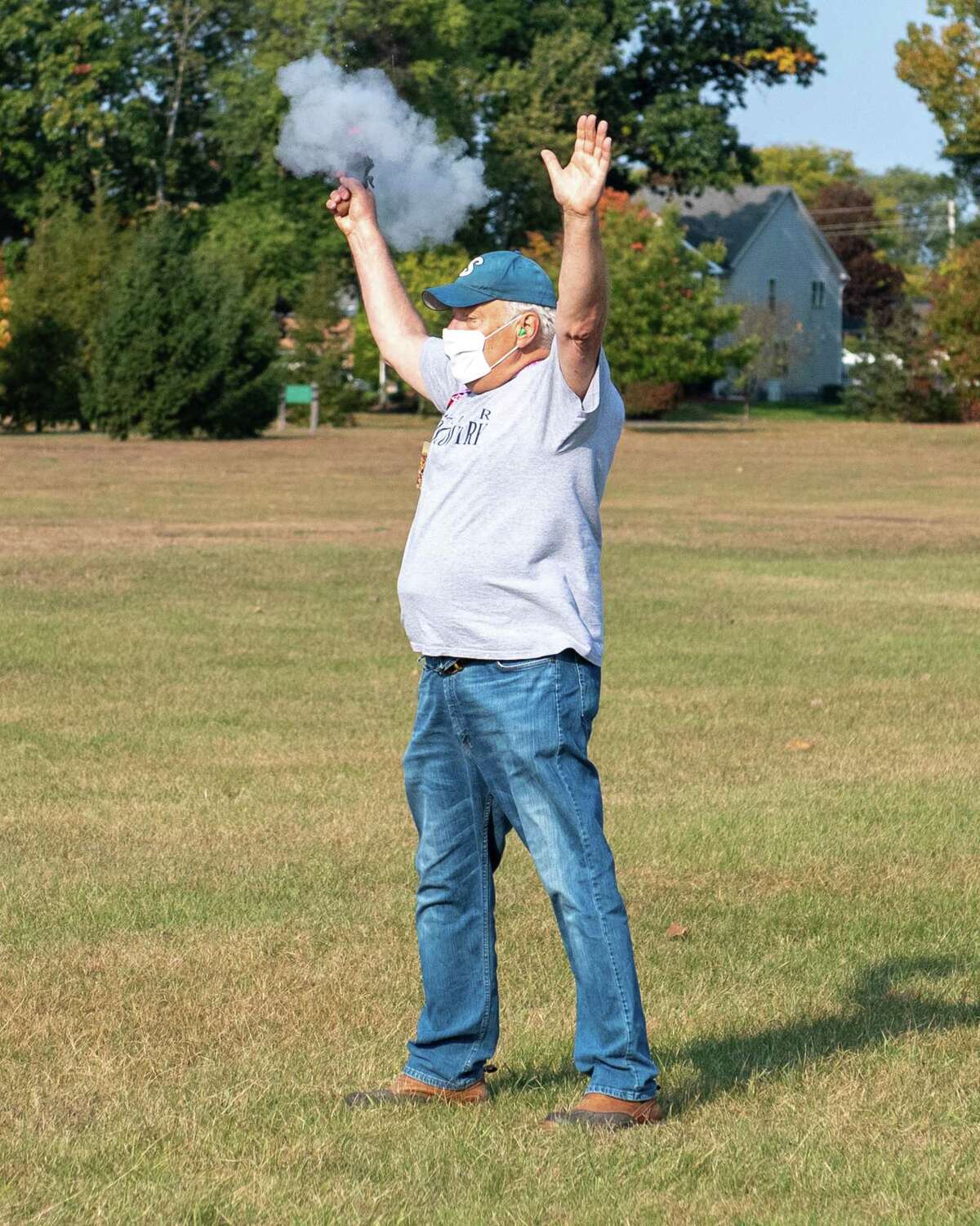 A masked Jim Libruk shoots the gun to start the Shaker High School girls varsity and junior varsity cross country race against Burnt Hills Ballston Lake at the Crossings in Colonie, NY, on Saturday, Oct. 10, 2020 (Jim Franco, special to the Times Union.)