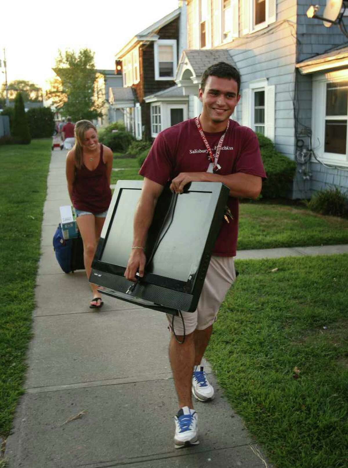 Fairfield University senior Mike Parent of Bethlehem, CT, carries his television to his rental house on Fairfield Beach on Monday, August 30, 2010.