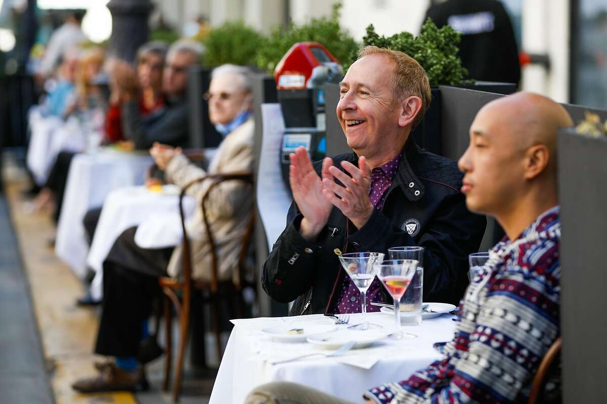 Dan Craft (center) applauds as Smuin Contemporary Ballet dancers perform for diners at John’s Grill Oasis on Ellis Street on Sunday in San Francisco.