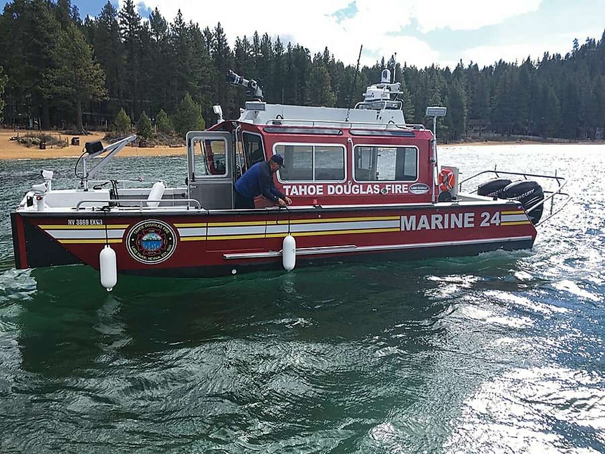 Members of the Tahoe Douglas fire district on Marine 24, a boat used in Friday's rescue of a man in Lake Tahoe. The man's partner died in the incident.