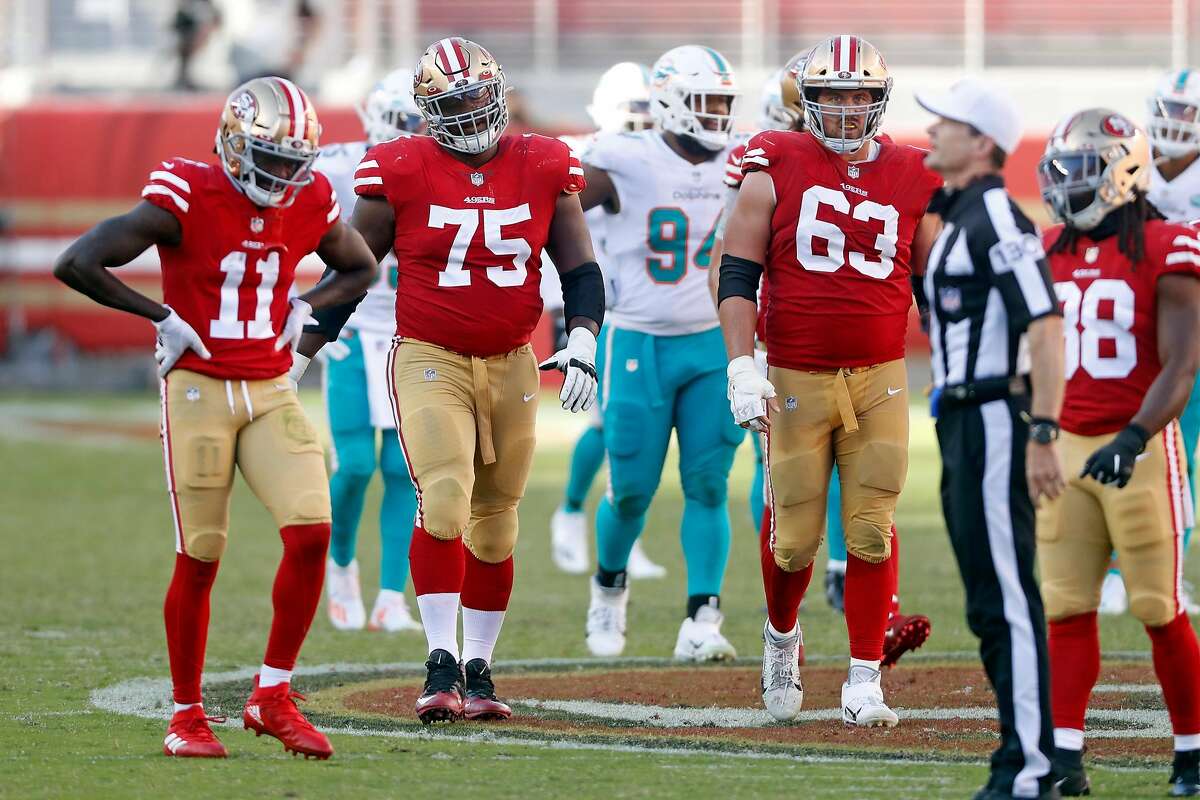 San Francisco 49ers' Brandon Aiyuk, Laken Tomlinson and Ben Garland hang their heads after 4th quarter penalty during Miami Dolphins' 43-17 win in NFL game at Levi's Stadium in Santa Clara, Calif., on Sunday, October 11, 2020.