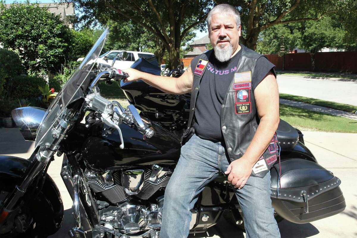 Thomas Kost polishes his motorcycles in the driveway of his home in Pflugerville on Sept. 29.