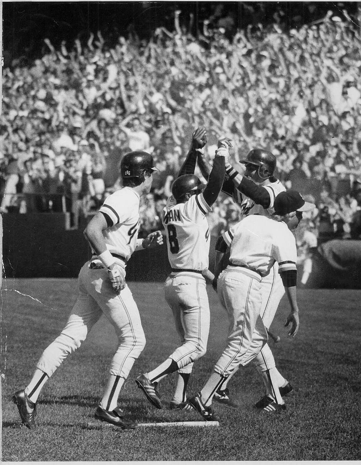 Giants teammates greet Joe Morgan at home plate after his home run on the last day of the 1982 season eliminated the Dodgers from the playoffs.
