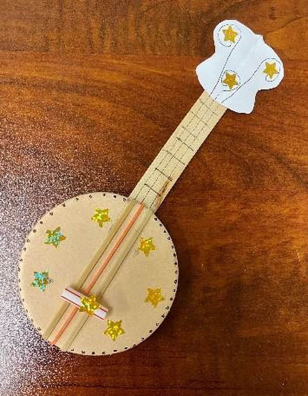 This children’s rubber band banjo activity was adapted from a Beyond the Briscoe craft lesson.