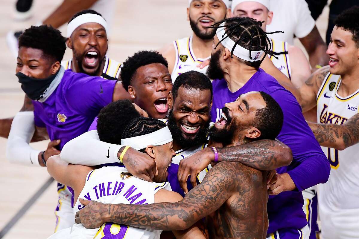 LAKE BUENA VISTA, FLORIDA - OCTOBER 11: LeBron James #23 of the Los Angeles Lakers celebrates with Quinn Cook #28 of the Los Angeles Lakers and teammates after winning the 2020 NBA Championship in Game Six of the 2020 NBA Finals at AdventHealth Arena at the ESPN Wide World Of Sports Complex on October 11, 2020 in Lake Buena Vista, Florida. NOTE TO USER: User expressly acknowledges and agrees that, by downloading and or using this photograph, User is consenting to the terms and conditions of the Getty Images License Agreement. (Photo by Douglas P. DeFelice/Getty Images) *** BESTPIX ***