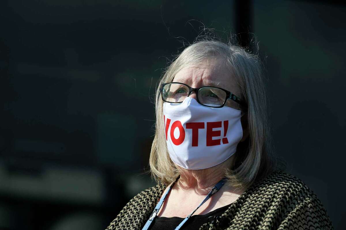 Bexar County Elections Administrator Jacque Callanen talks with reporters wearing a particularly appropriate mask, Monday, Oct. 12, 2020. Early voting starts Tuesday and Callanen said that more than 1.1 million have registered to vote, a 12 percent increase over the last presidential election in 2016.