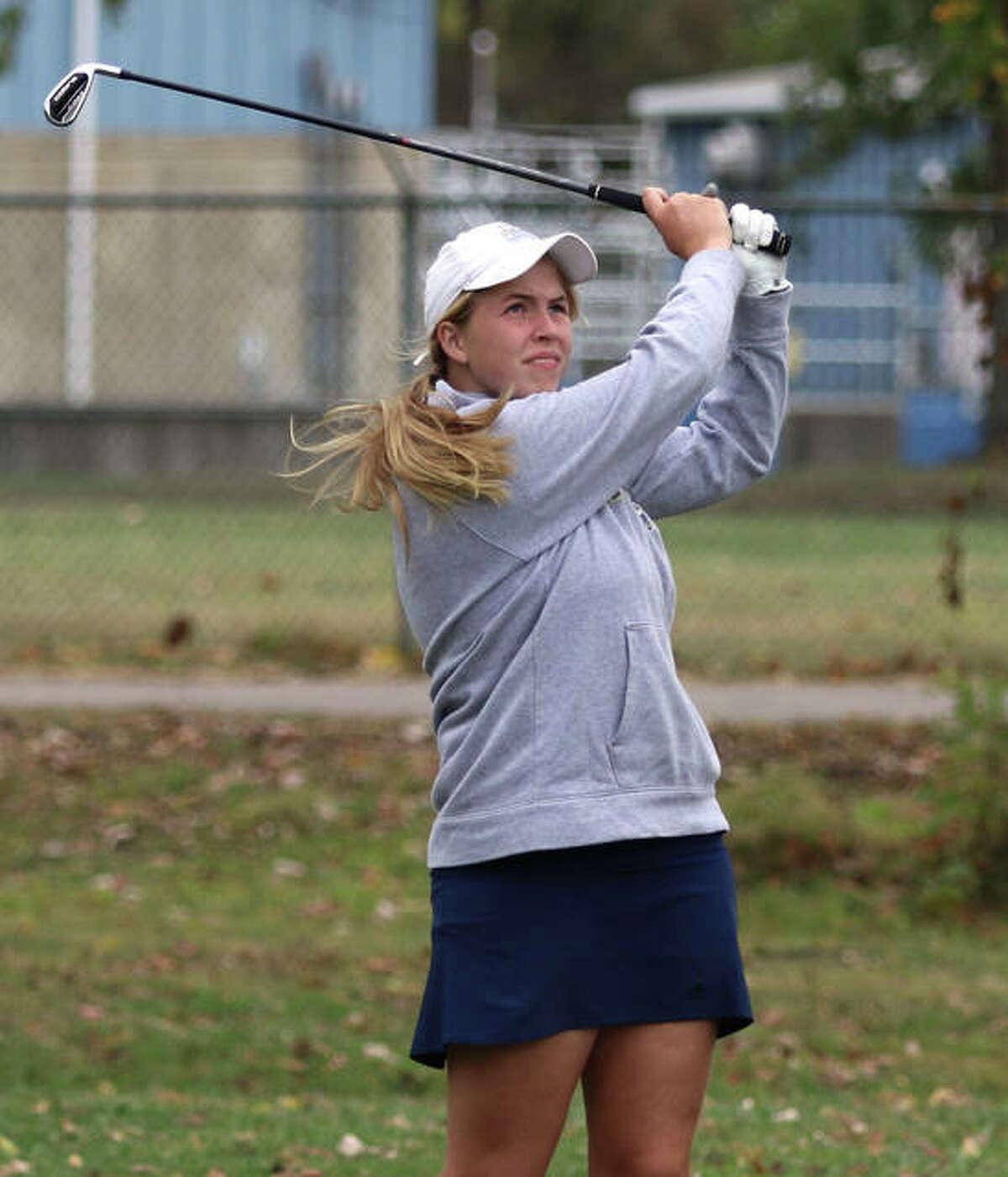 Father McGivney’s Julis Stobie watches her tee shot on No. 7 at the Salem Country Club during Monday’s sectional.