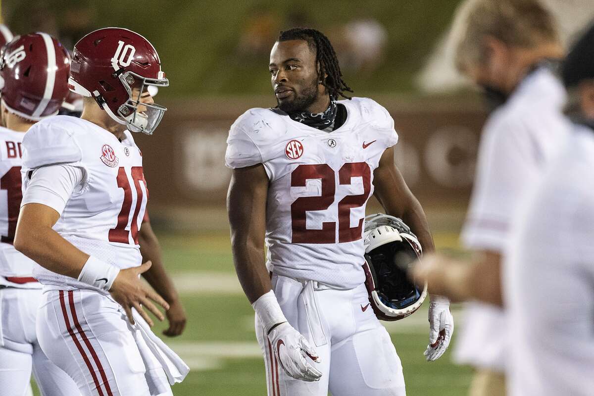 Alabama running back Najee Harris, right, jokes with quarterback Mac Jones, left, as they walk off the field during the second half of an NCAA college football game against Missouri, Saturday, Sept. 26, 2020, in Columbia, Mo. (AP Photo/L.G. Patterson)