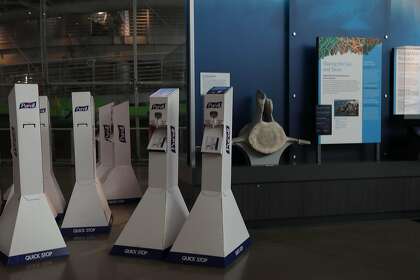 Hand sanitizing stations are seen in the Giants of Land and Sea section before set up around the the California Academy of Sciences on Monday, October 12, 2020 in San Francisco, Calif. The California Academy of Sciences is scheduled to reopen on October 13 for members only since being shut down in March.