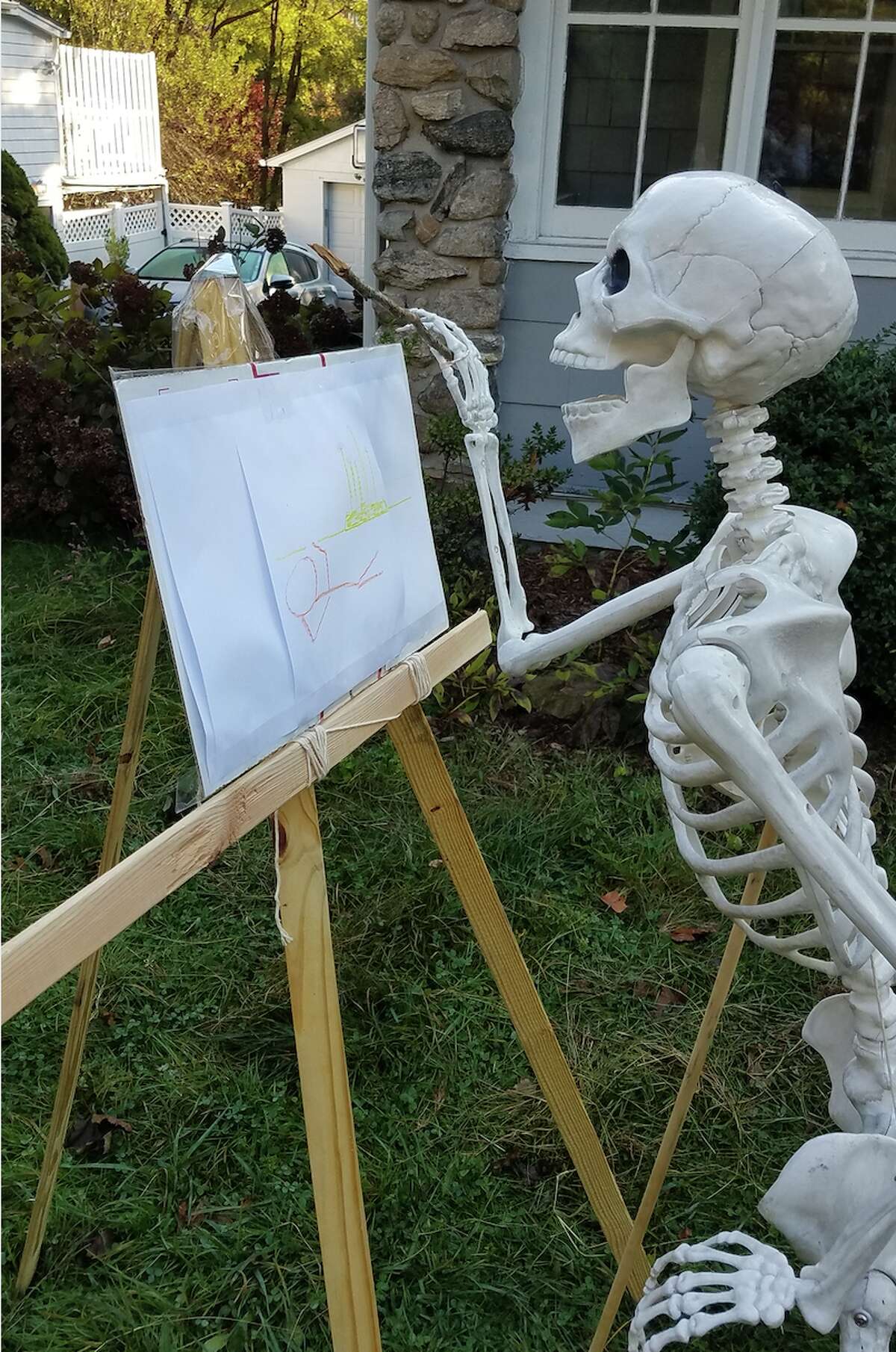 The skeletons have been seen sword fighting from atop their “horses,” sitting around a “campfire,” and “fishing” in a kiddy pool that belongs to the Dummeyers’ 14-month-old daughter. In Mike Dummeyer’s favorite set-up, one skeleton spent the day giving the other a haircut.  