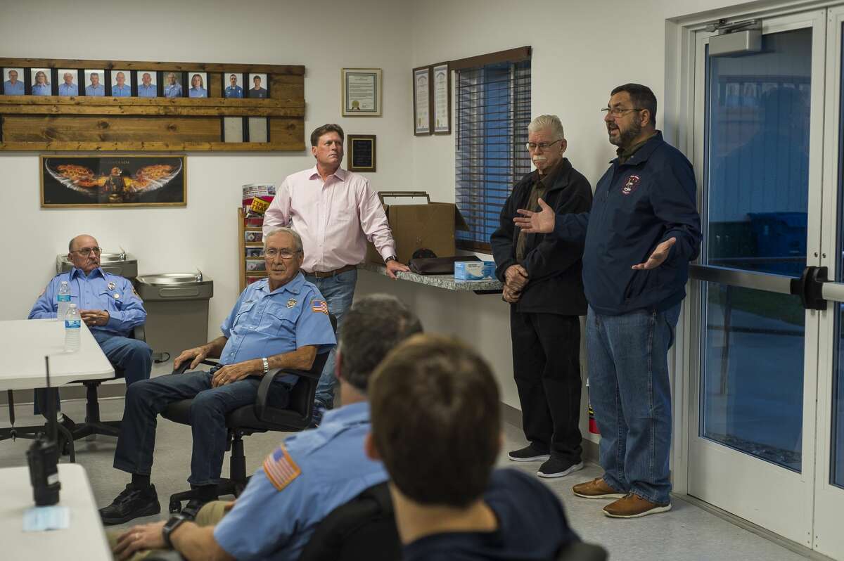 State Sen. Jim Stamas, right, and State Rep. Roger Hauck, left, speak to members of the Edenville Township Fire Department during a ceremony Monday, Oct. 12, 2020 to thank them for their efforts during the May 19 dam failures. (Katy Kildee/kkildee@mdn.net)