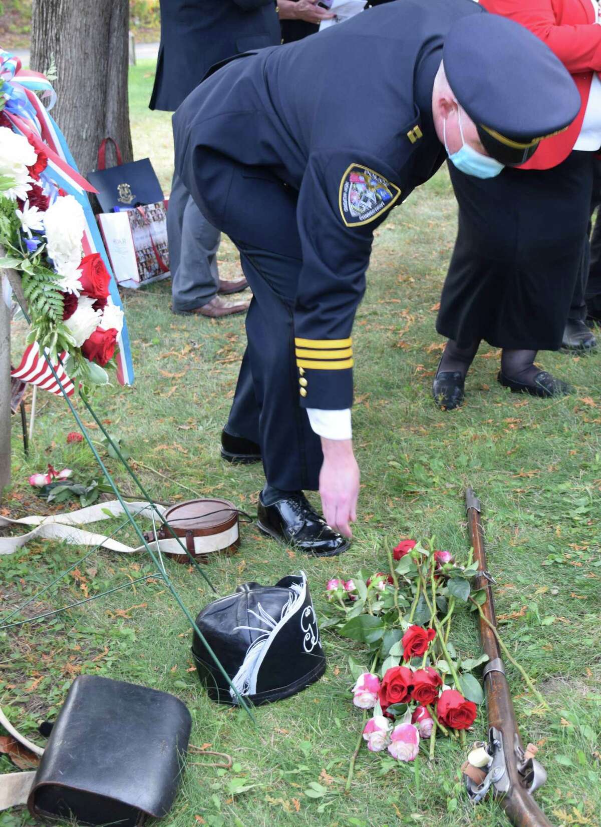 New Milford Police Captain Al Wilcox places a rose at the grave sites of the Phillips brothers. DAR members joined William Fothergill, of Hartford, a descendant of the Phillips men, as guests listened closely while social distancing as the history of the men was shared by local genealogist Kathleen Zuris. State Rep. Bill Buckbee, R-67, presented a a proclamation for the special occasion from the state General Assembly. It was signed by Buckbee, state Rep. Richard Smith of the 108th House District and state Sen. Craig Miner, R-30.