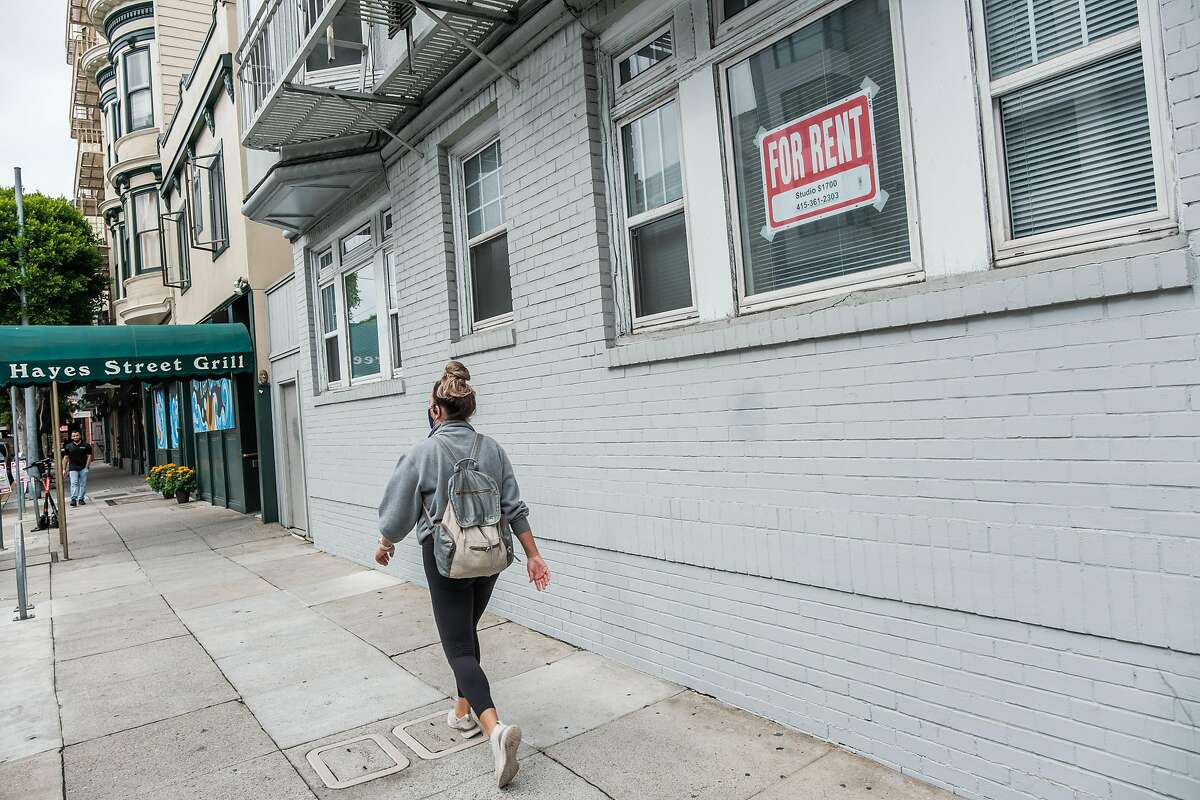 A pedestrian walks past t a “For Rent” sign in a window on Hayes Street in San Francisco on Friday, October 9, 2020.