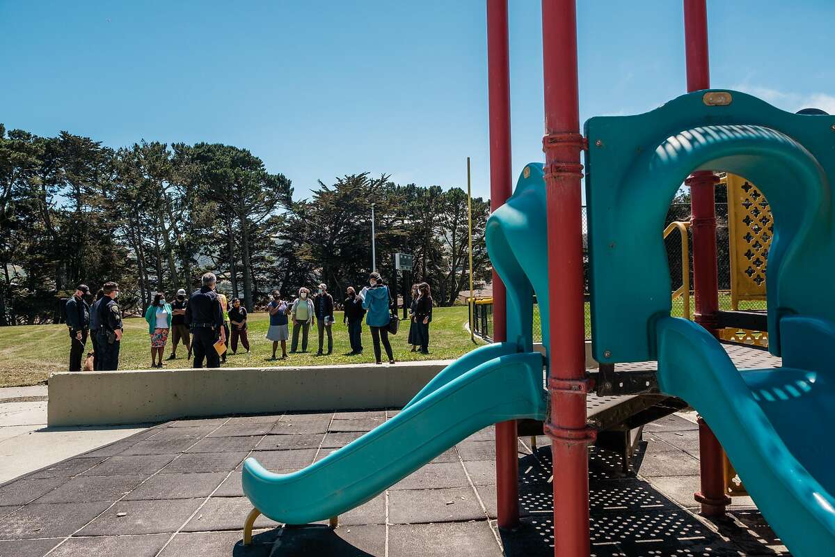 Dr. Kim Rhoads, center, inspects Herz Playground in Visitacion Valley along with other community organizers and consultants in San Francisco on Thursday, May 28, 2020. The Herz playground will be where UCSF and SFDPH are launching a testing surveillance program this weekend.
