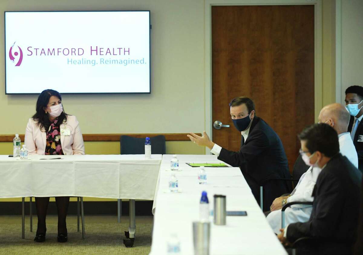Sen. Chris Murphy, D-Conn., right, speaks during the COVID-19 roundtable discussion at Stamford Hospital on Tuesday. Murphy joined Stamford Health President and CEO Kathleen Silard, Chair of Infectious Diseases Dr. Michael Parry and other clinical leaders to discuss the current state of coronavirus cases, future vaccines, testing, PPE, and more.