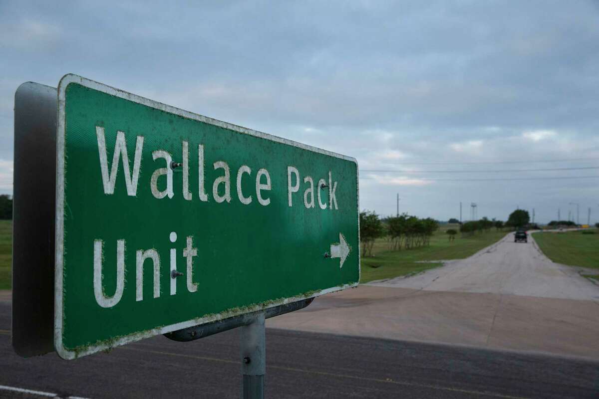 A road sign pointing to the Wallace Pack Unit is seen at dawn on Wednesday, Aug. 9, 2017, in Navasota. ( Yi-Chin Lee / Houston Chronicle )