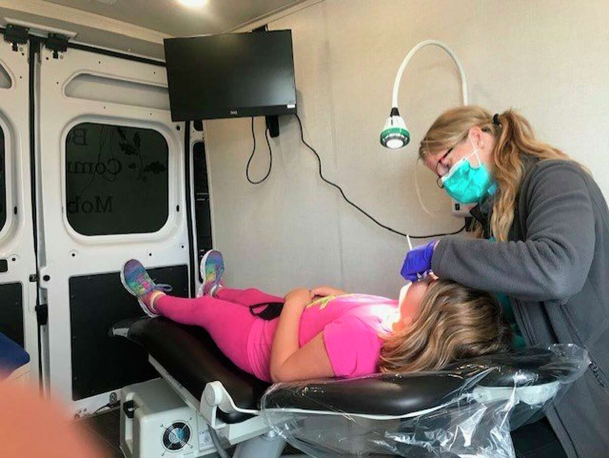 Dental hygienist, Jennifer Kerns performs routine dental care in a new mobile dental van that will begin providing free care to school aged children in Benzie and Manistee Counties. (Courtesy Photo)