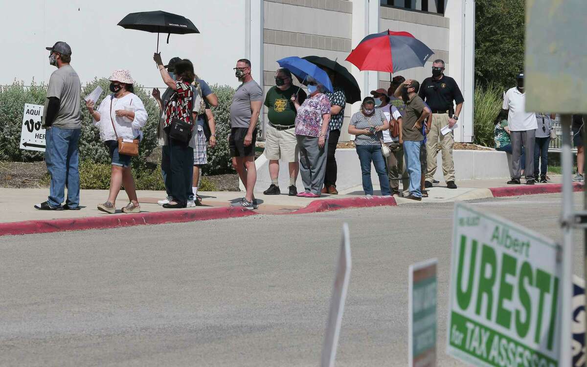 People wait in line - some for several hours - at the Northside Activity Center for early voting on Tuesday, Oct. 13, 2020.