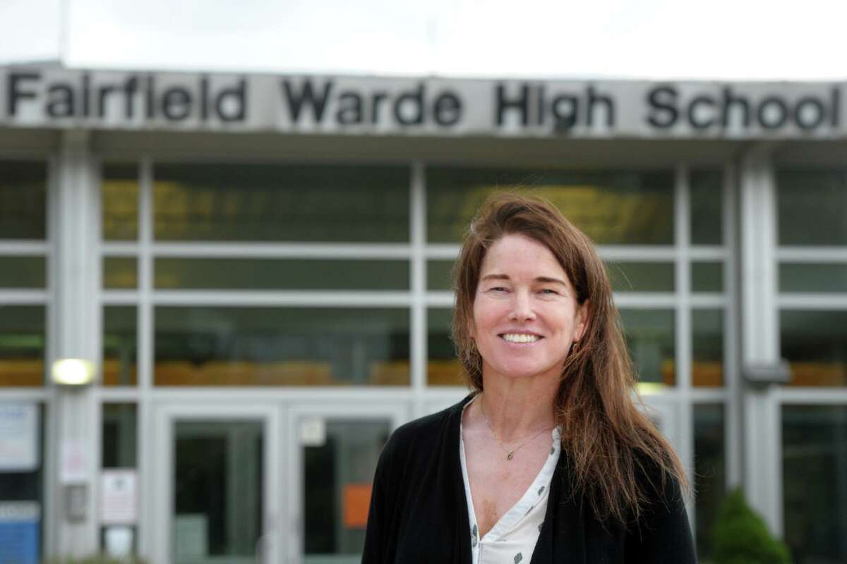 History teacher Margaret Murphy poses in front of Fairfield Warde High School, in Fairfield, Conn. Oct. 7, 2020. Murphy has received the University of Chicago Outstanding Educator Award.