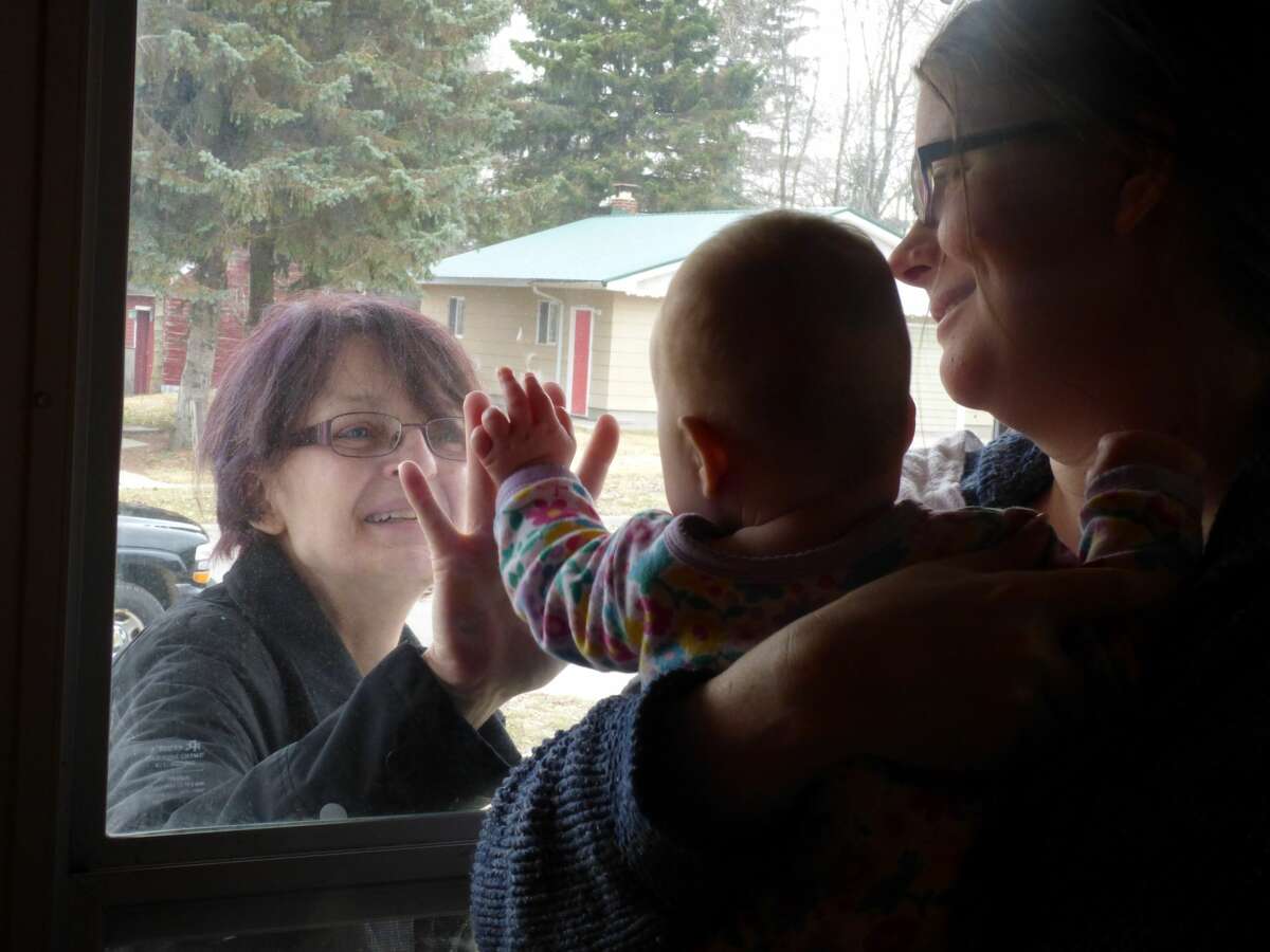 Maya Grace Fraley reaches for her grandmother during the pandemic lockdown.