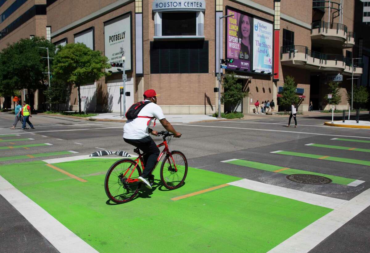 A biker passes through the intersection of Lamar and Austin bike lanes Wednesday, Sept. 30, 2020, in Downtown Houston.