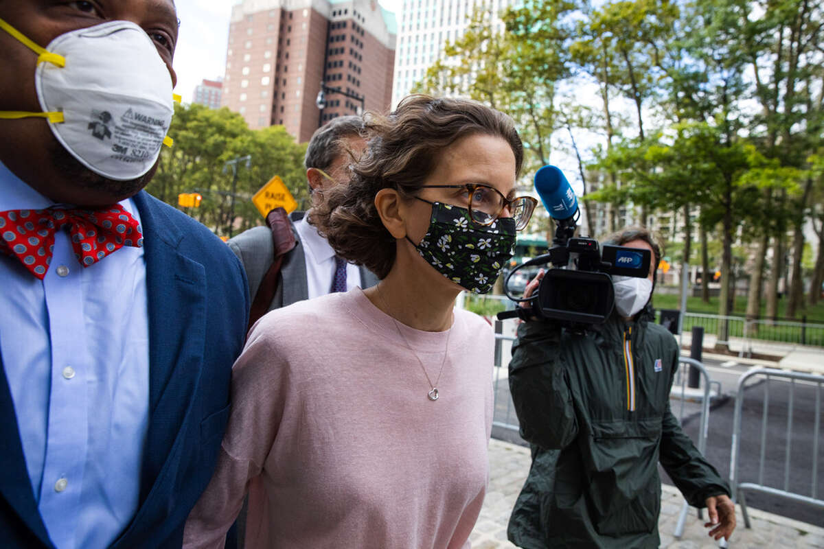 Clare Bronfman, daughter of former Seagram Chairman Edgar M. Bronfman, center, arrives at federal court in the Brooklyn borough of New York, U.S., on Wednesday, Sept. 30, 2020. Bronfman was charged with helping finance the activities of Nxivm, an upstate New York cult accused of branding its victims and forcing them to participate in sex acts. She pleaded guilty to conspiracy charges and could spend more than two years in federal prison. Photographer: Paul Frangipane/Bloomberg