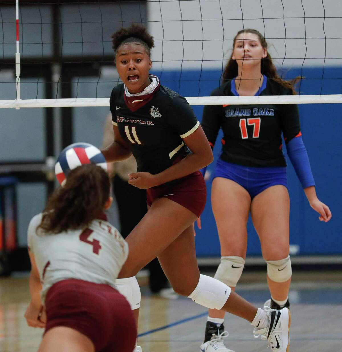 Summer Creek middle hitter Imari Wilson (11) looks on as libero Alaryss Medina (4) returns a hit during a non-district high school volleyball match at Grand Oaks High School, Tuesday, Sept. 29, 2020, in Spring.