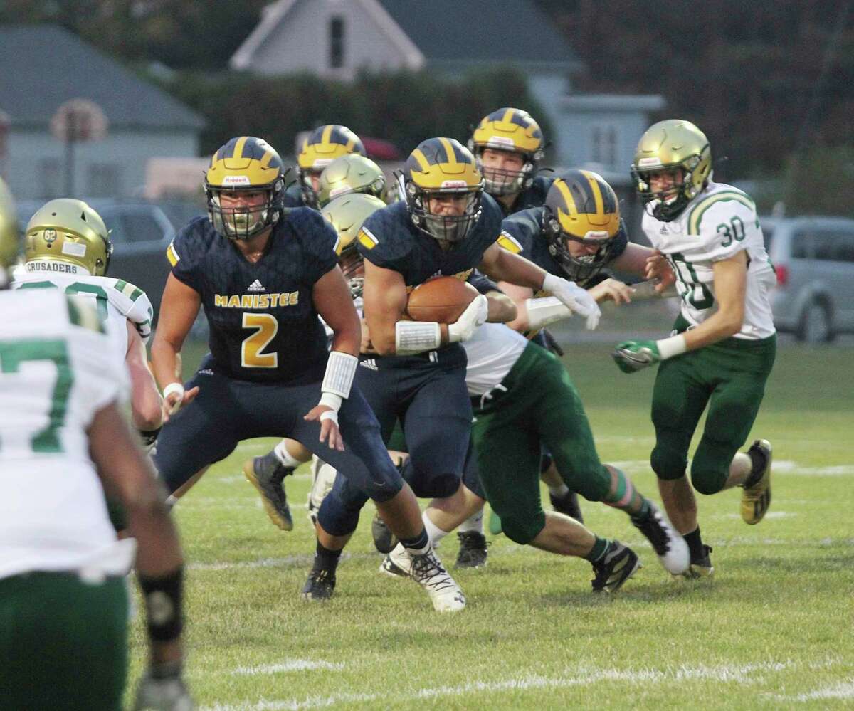 Manistee's Brady Mikula (2) looks to block for running back Landen Powers during the Chippewas' loss to Muskegon Catholic Central last week. (News Advocate file photo)