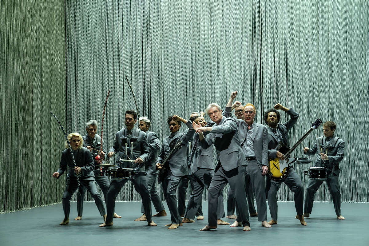 David Byrne, front, appears onstage with the cast of "American Utopia" in Spike Lee's film documenting the Broadway show.