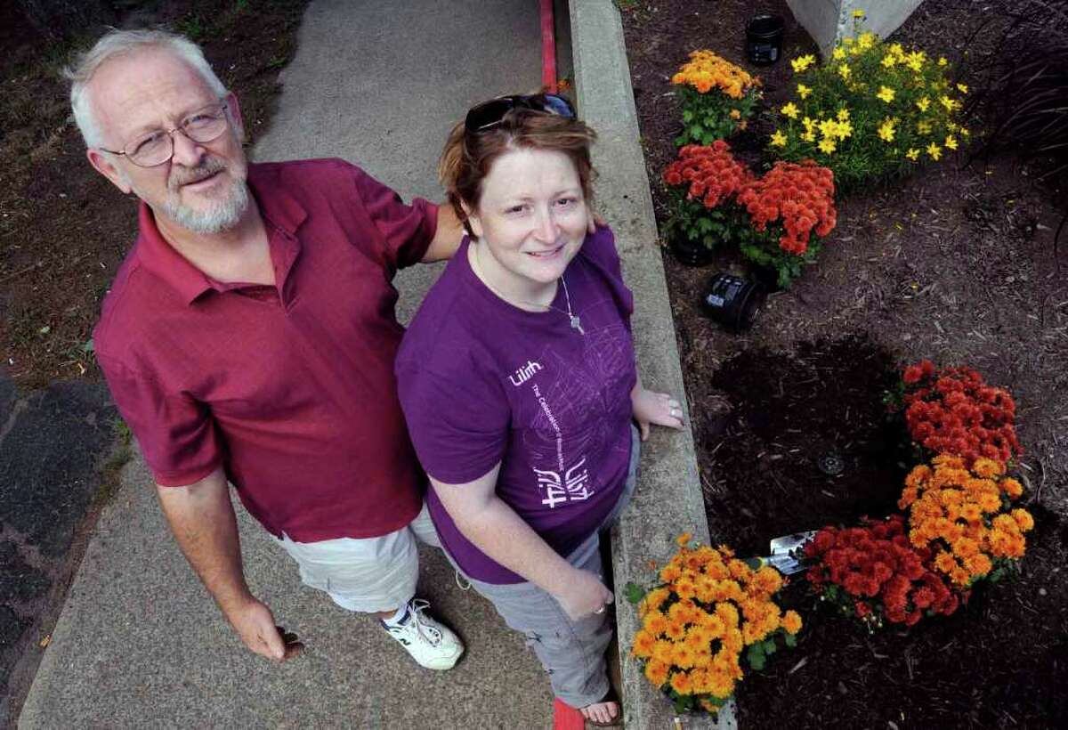 Theresa Thibodeau and her father, Patrick Thibodeau, joined Cohoes' Adopt-A-Park Program this year. They adopted Canal Square where concerts are held. They cleaned up the park and planted flowers. They maintain it for the city .8/28/2010. ( Michael P. Farrell / Times Union )