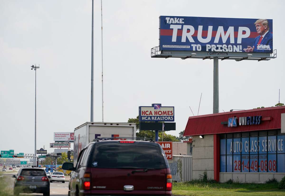 A Trump billboard is shown vandalized along I-45 southbound near Telephone Road Tuesday, October 13, 2020 in Houston.