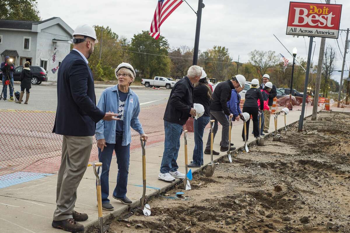 The Sian family, owners of Sanford Hardware, are joined by community members to celebrate with a groundbreaking ceremony for the new store Thursday morning, Oct. 15, 2020 in downtown Sanford. (Katy Kildee/kkildee@mdn.net)