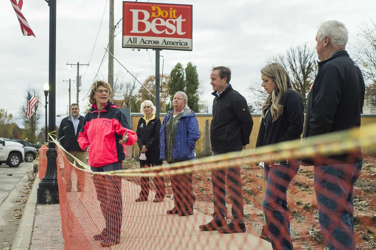 Sanford Village President Dolores Porte speaks as the Sian family, owners of Sanford Hardware, are joined by community members to celebrate with a groundbreaking ceremony for the new store Thursday morning, Oct. 15, 2020 in downtown Sanford. (Katy Kildee/kkildee@mdn.net)