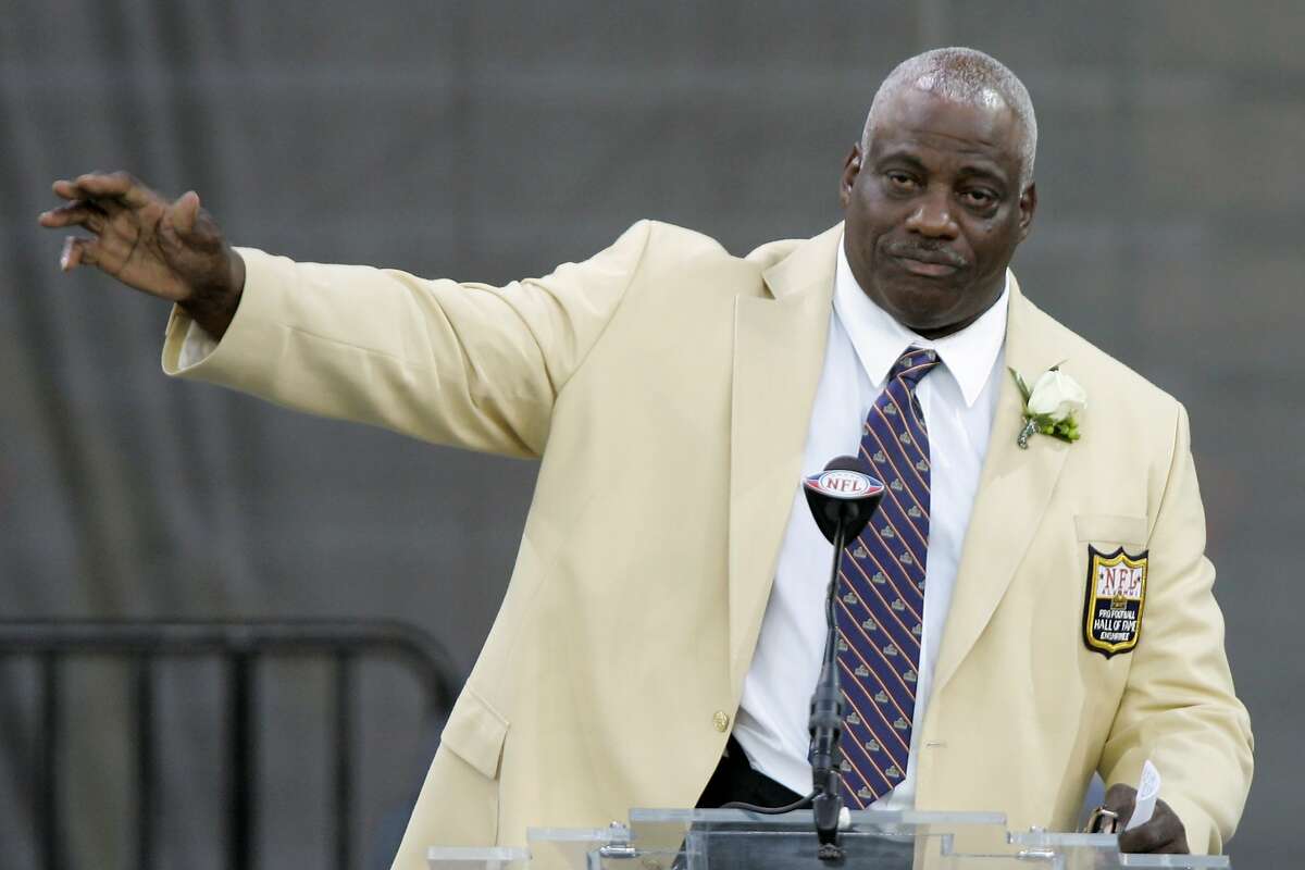 In this Saturday, Aug. 2, 2008, file photo, former San Diego Chargers defensive end Fred Dean waves to fans after his speech at the Pro Football Hall of Fame, in Canton, Ohio. Dean, the fearsome pass rusher who was a key part of the launch of the San Francisco 49ers' dynasty, has died. He was 68. His death on Wednesday night, Oct. 14, 2020, was confirmed Thursday by the Pro Football Hall of Fame in Canton, Ohio.
