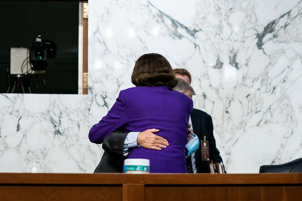Senate Judiciary Committee Chairman Sen. Lindsey Graham, R-S.C., and Sen. Dianne Feinstein, D-Calif., hug Thursday after the end of the fourth day of committee hearings for Supreme Court nominee Amy Coney Barrett.
