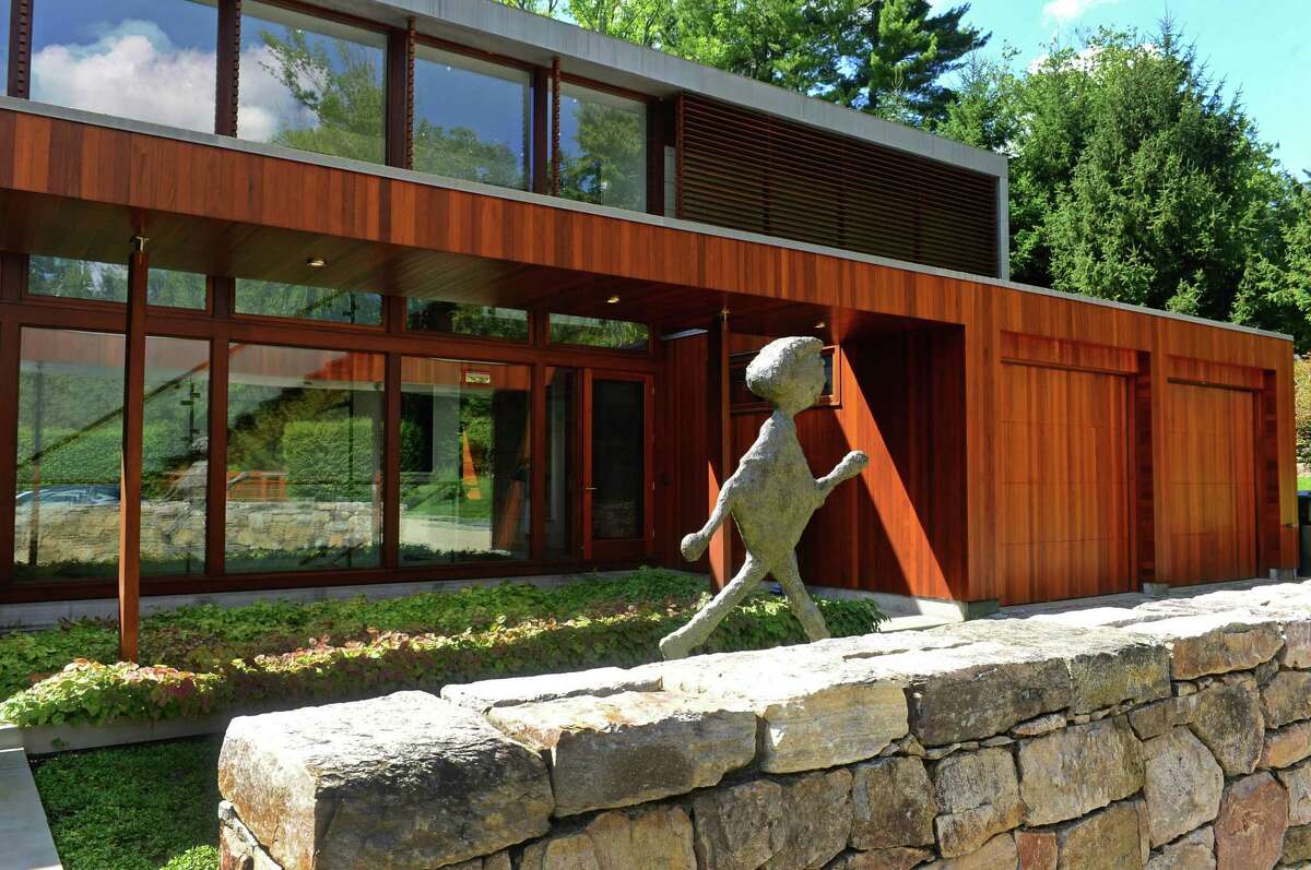 The front exterior of the mid-century modern home designed by renown architect Eliot Noyes and referred to as "The Brown House" at 81 Cross Ridge Road in New Canaan.