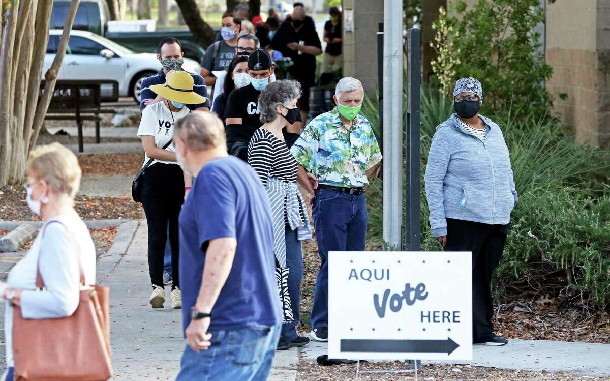 Voters wait in a line at Brookhollow Library on Oct. 14, 2020.