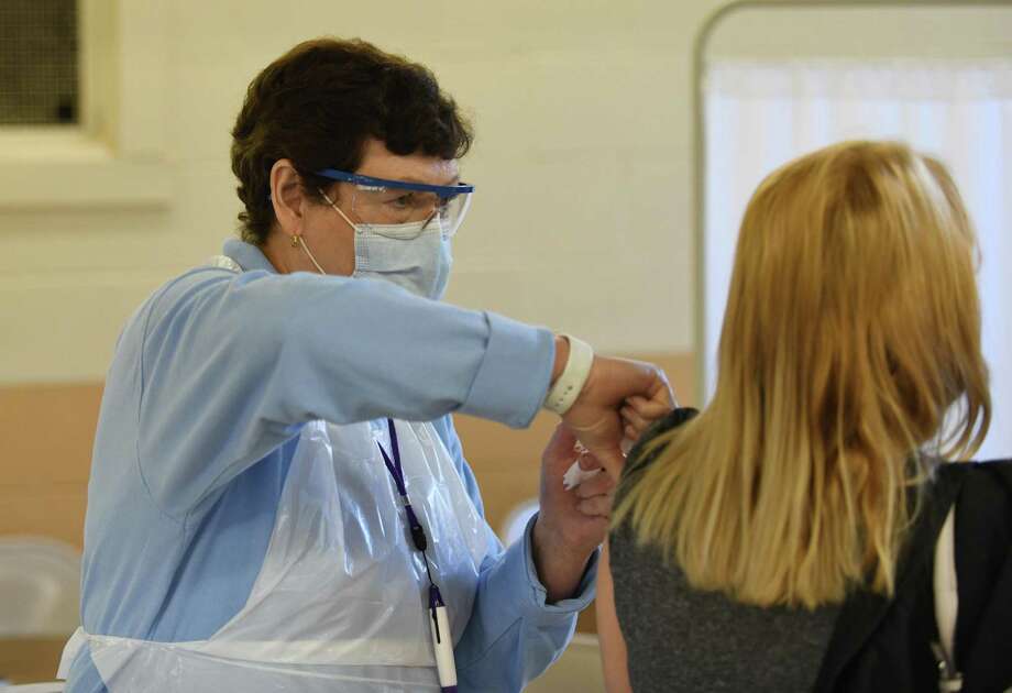 A nurse administers a flu shot at the Eastern Greenwich Civic Center in Old Greenwich, Conn. Wednesday, Oct. 14, 2020. Photo: Tyler Sizemore / Hearst Connecticut Media / Greenwich Time