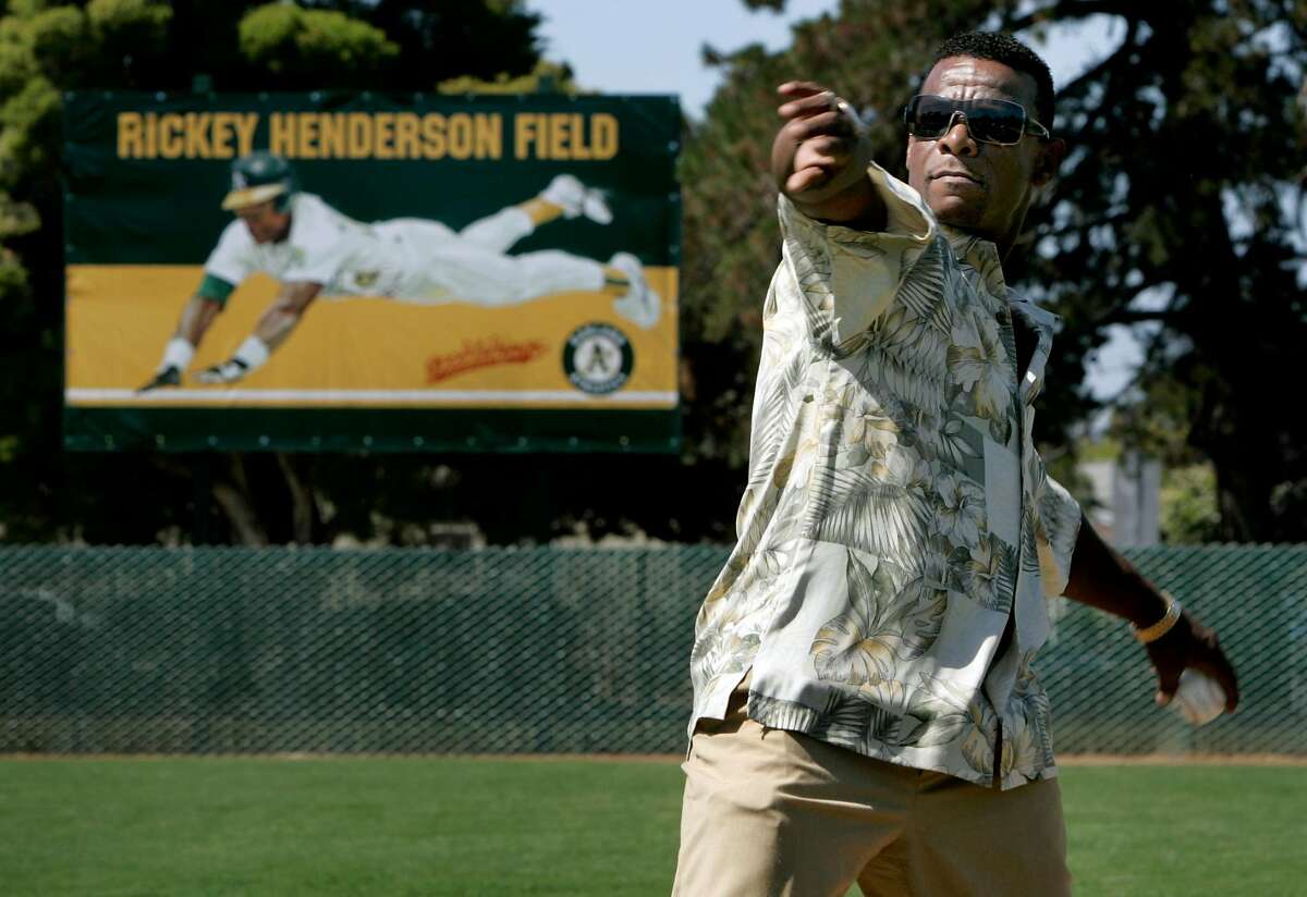 Rickey Henderson throws out the first pitch at the dedication ceremony for Rickey Henderson Field at the Arroyo Viejo Recreation Center in Oakland in 2006.
