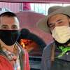Sal Bagliavio and Frank Candullo, Bailey’s Backyard masked pizza duo, in front of the restaurant’s new mobile pizza oven.