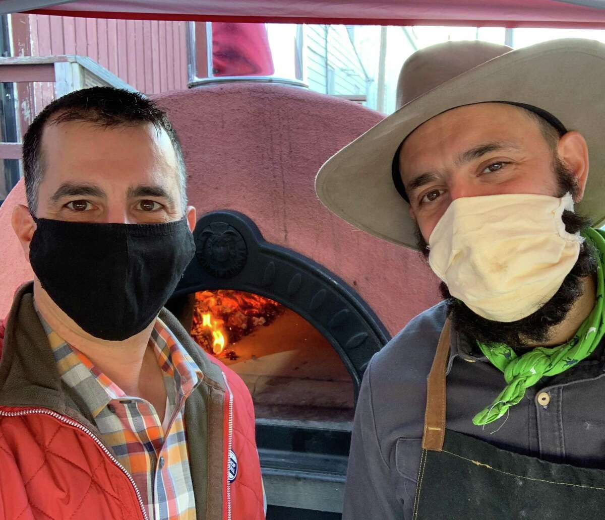 Sal Bagliavio and Frank Candullo, Bailey’s Backyard masked pizza duo, in front of the restaurant’s new mobile pizza oven.
